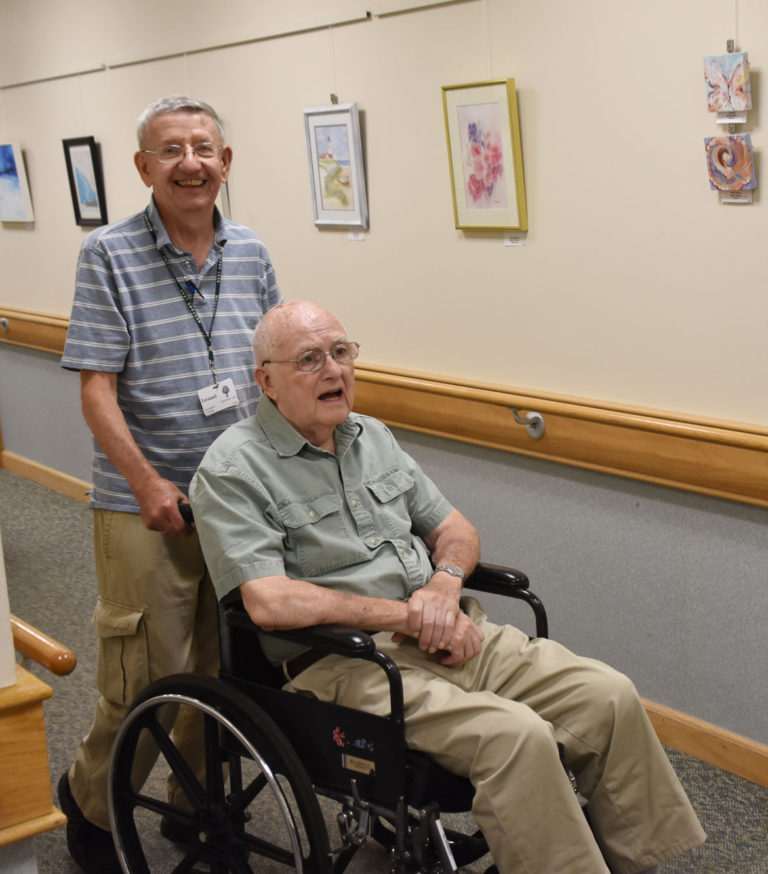 Health Volunteer pushing wheelchair